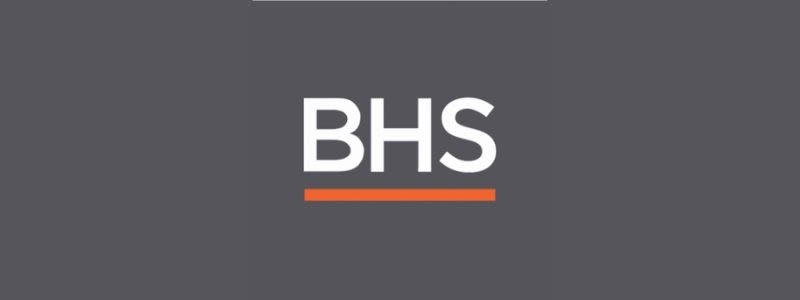 The word BHS is written in all capital letters, in white text. The name is set on a grey background, with an orange line underneath. 