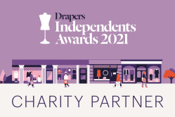 The white text across a purple background reads, Drapers Independent Awards 2021. Underneath are illustrated shop fronts, to represent independent retailers. 